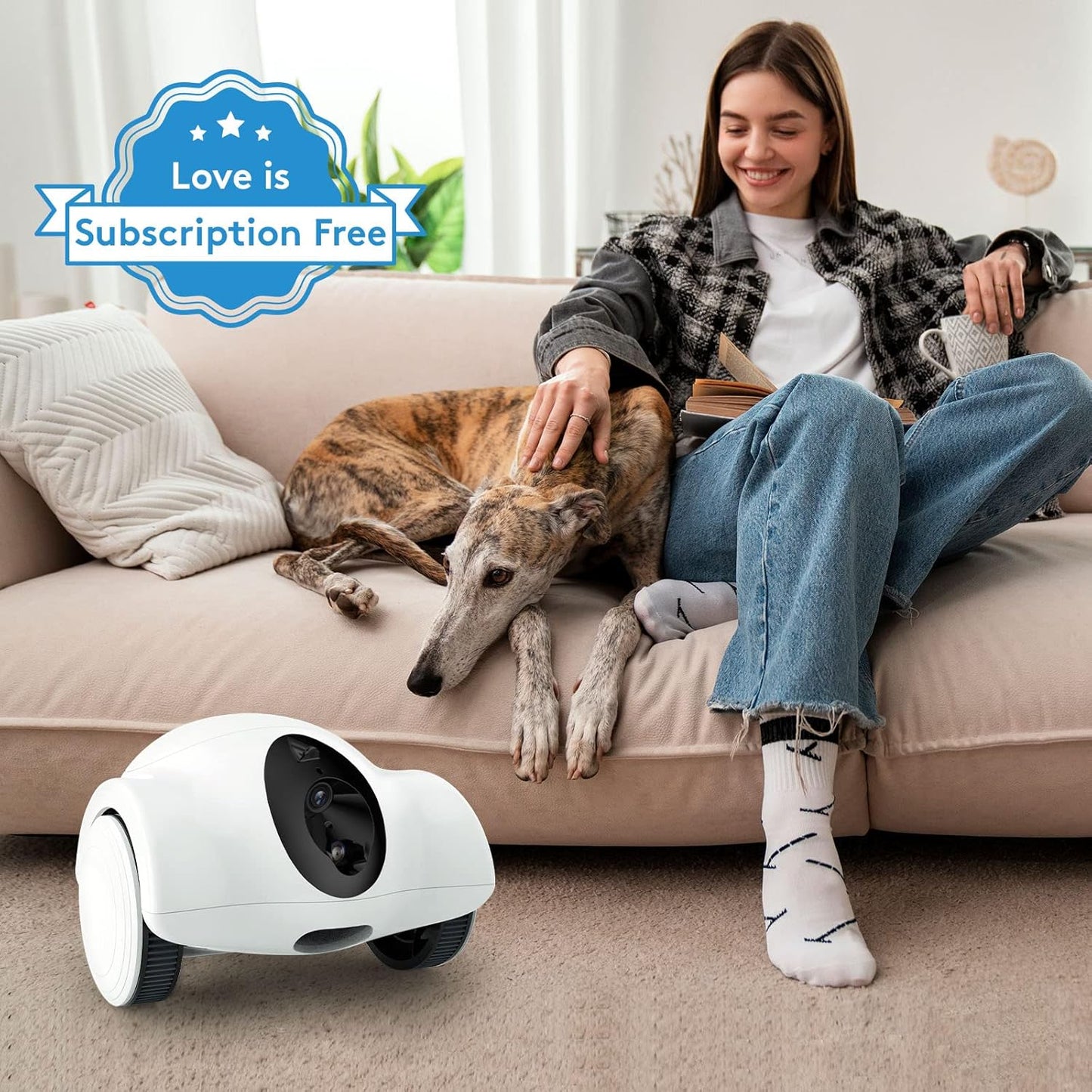 Smart Pet Robot Camera with Treat Dispenser on the floor next to a woman and her dog on the couch.