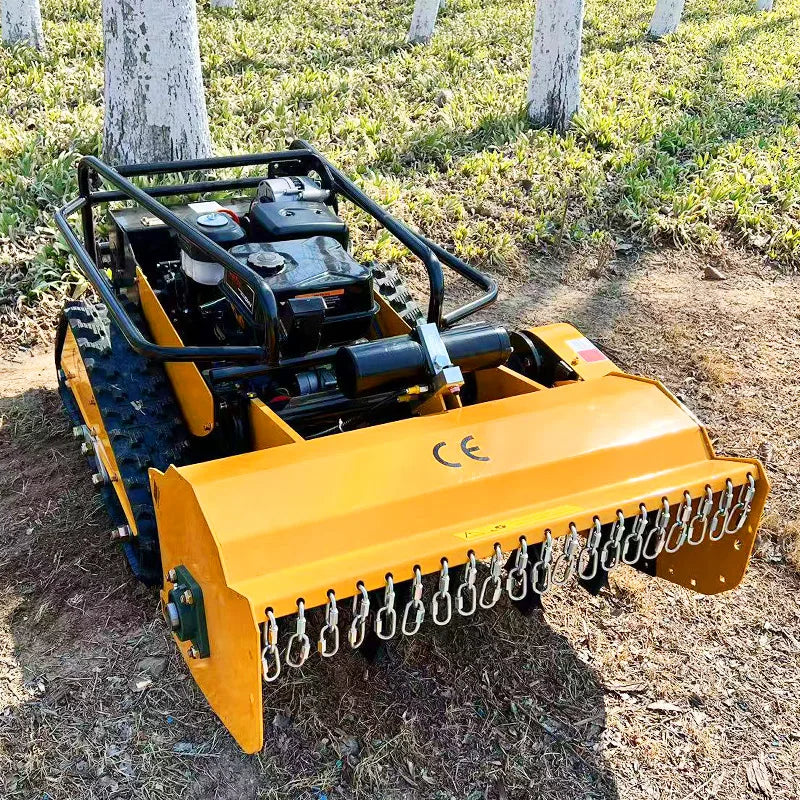 Remote Control Flail Crawler Mower viewed from the back on a grassy terrain.