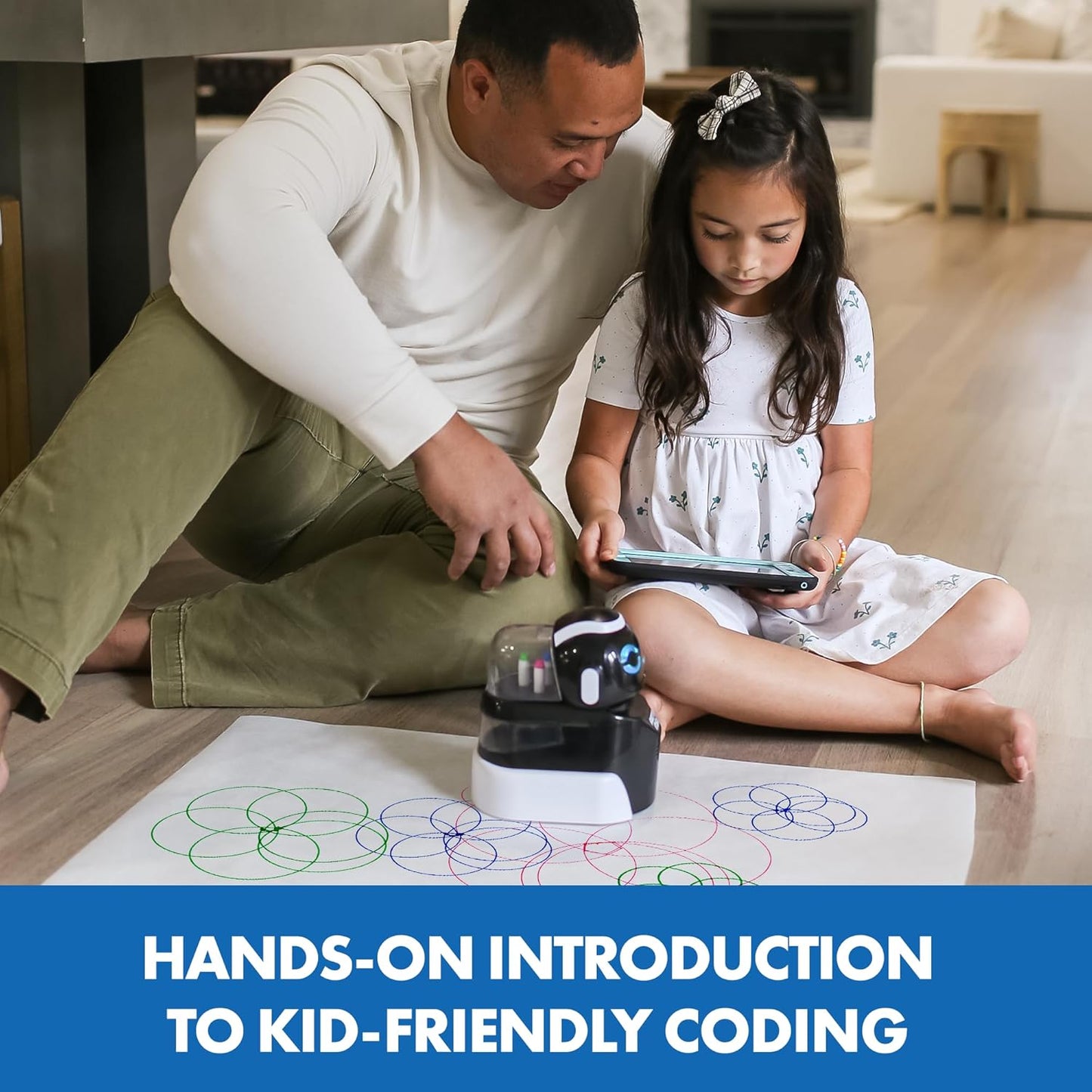 Father and daughter engaging with coding drawing robot STEM toy for a hands-on coding experience.