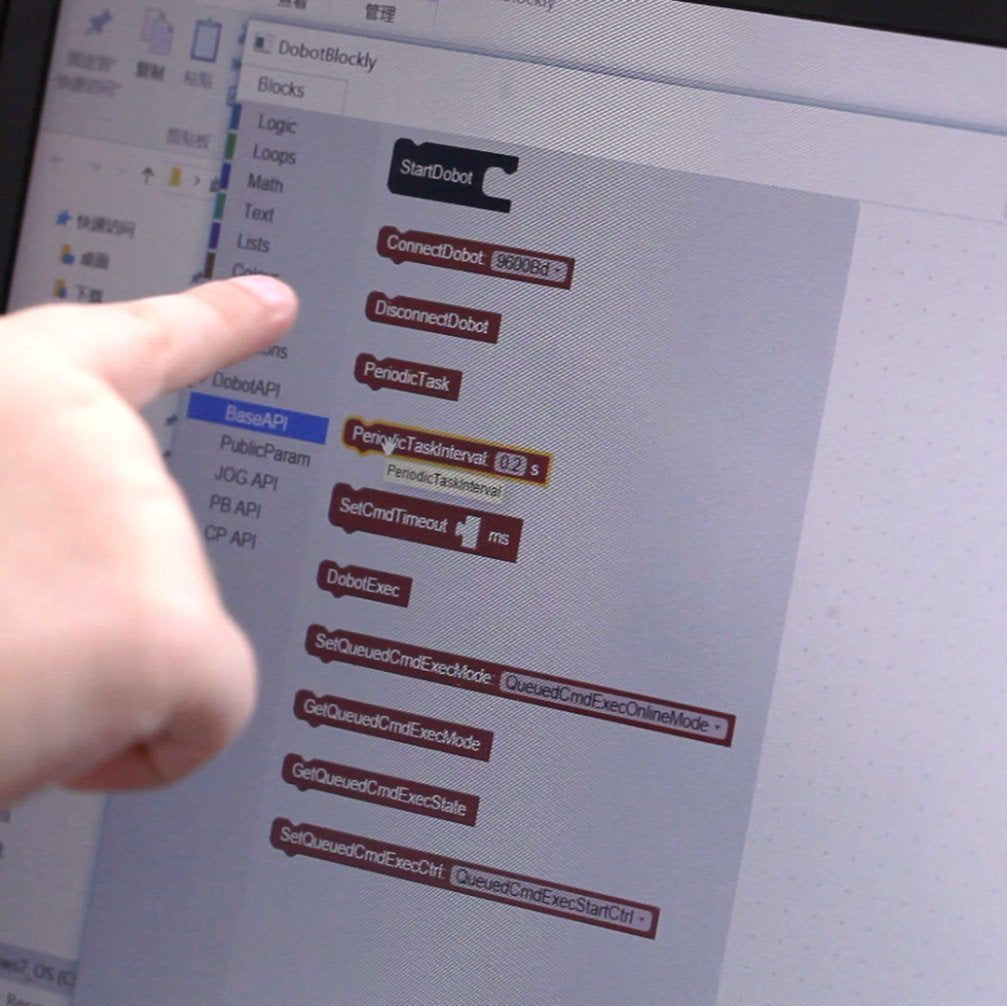 A hand pointing at coding blocks on a computer screen related to K12 STEM educational magician kit.