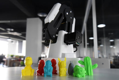 K12 STEM educational magician kit with a robotic arm and colorful 3D printed models in a classroom setting.