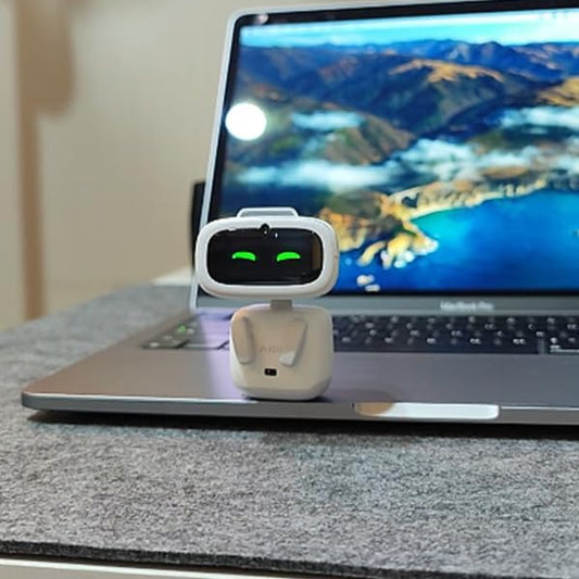 Ultra-portable wearable robot next to a laptop with a scenic background, showcasing its compact design.