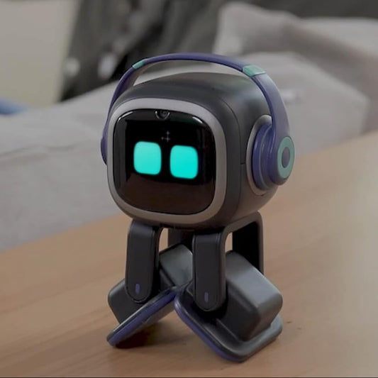 Emo ChatGPT-Enabled AI Desk Robot Companion on a desk with expressive eyes and headphones.