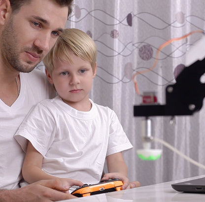 Father and son engaging with K12 STEM educational magician kit, showcasing interactive learning and experimentation.