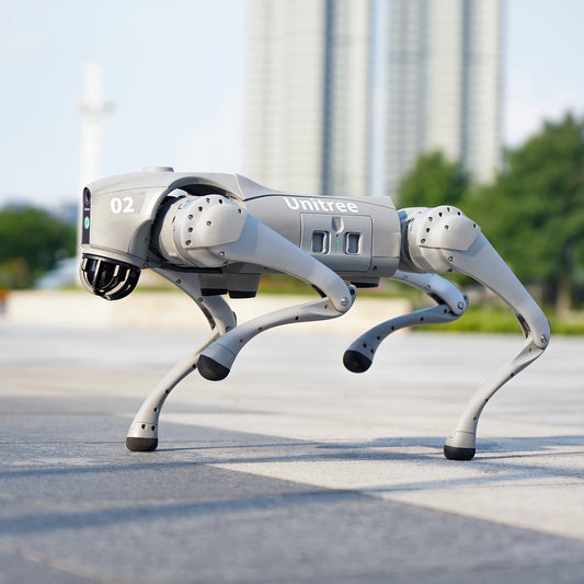 Quadruped robot dog Unitree walking on a pathway in an outdoor setting.